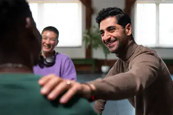 A supportive group setting showing individuals learning how to recover from opiate addiction through connection and shared activities.