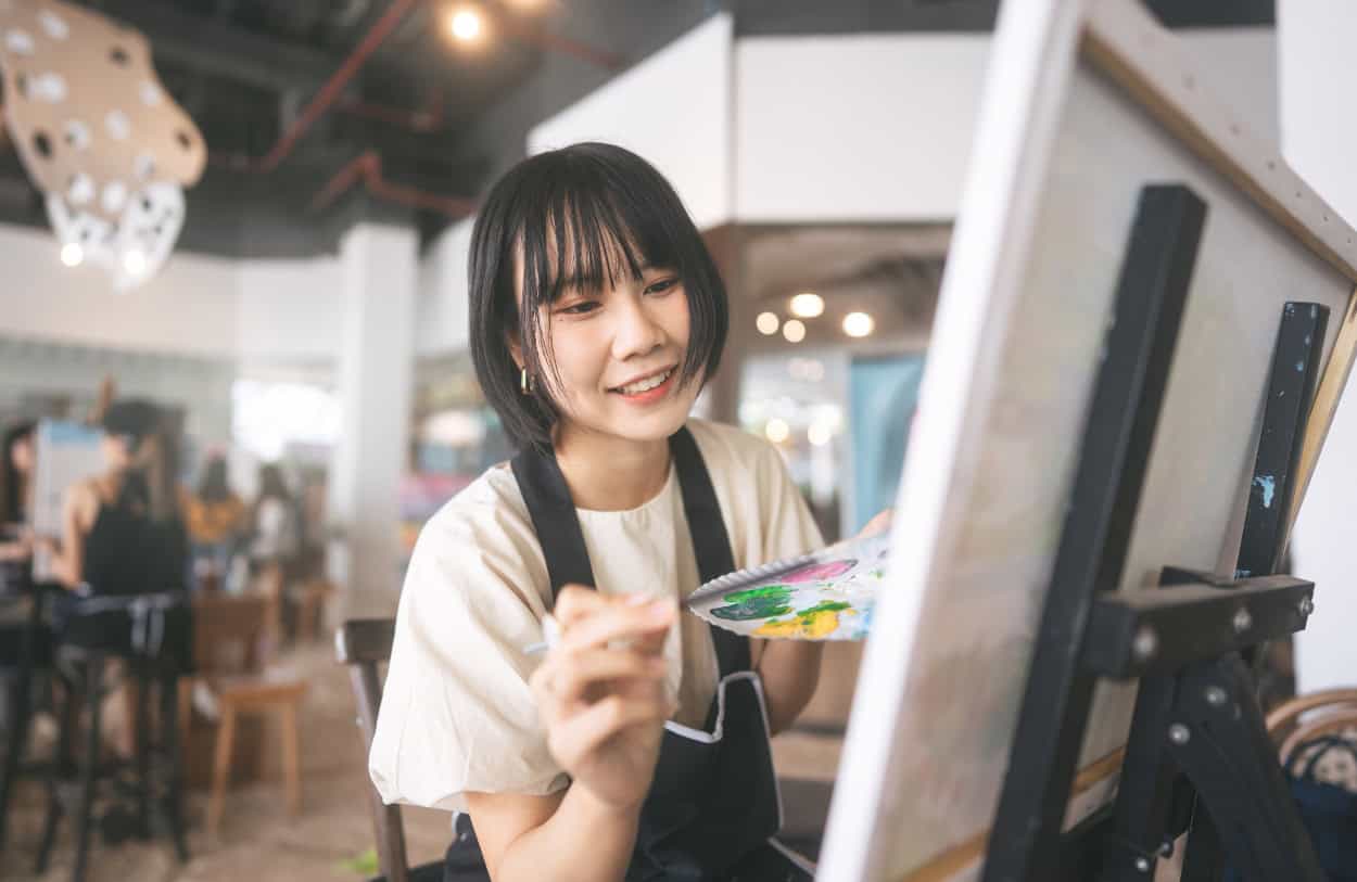 A woman enjoys painting through art therapy in Massachusetts.