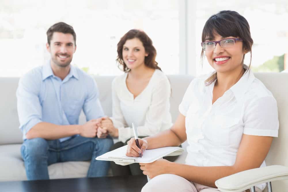 Therapist smiling with patients during confidential addiction treatment for working professionals in Massachusetts at Brook Recovery Centers.