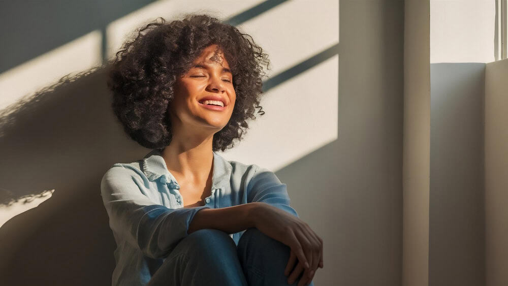 Young woman smiling peacefully while experiencing improved well-being during dual diagnosis depression treatment in Massachusetts.