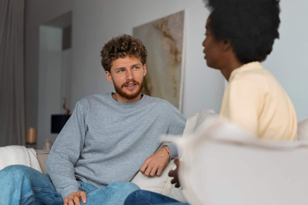 Young therapist providing personalized support during men's rehab in Massachusetts at Brook Recovery Centers.