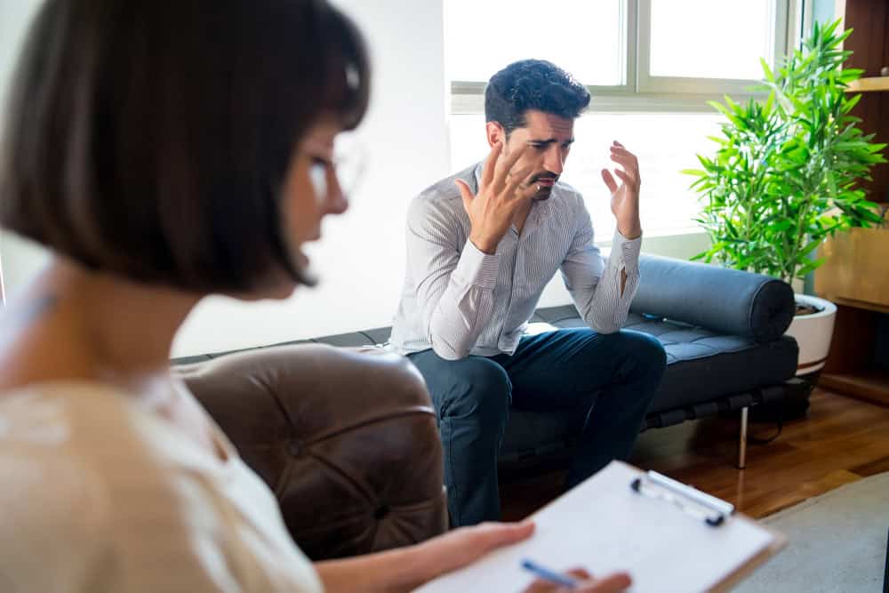 Woman smiling while speaking with her therapist during dual diagnosis OCD treatment in Massachusetts.