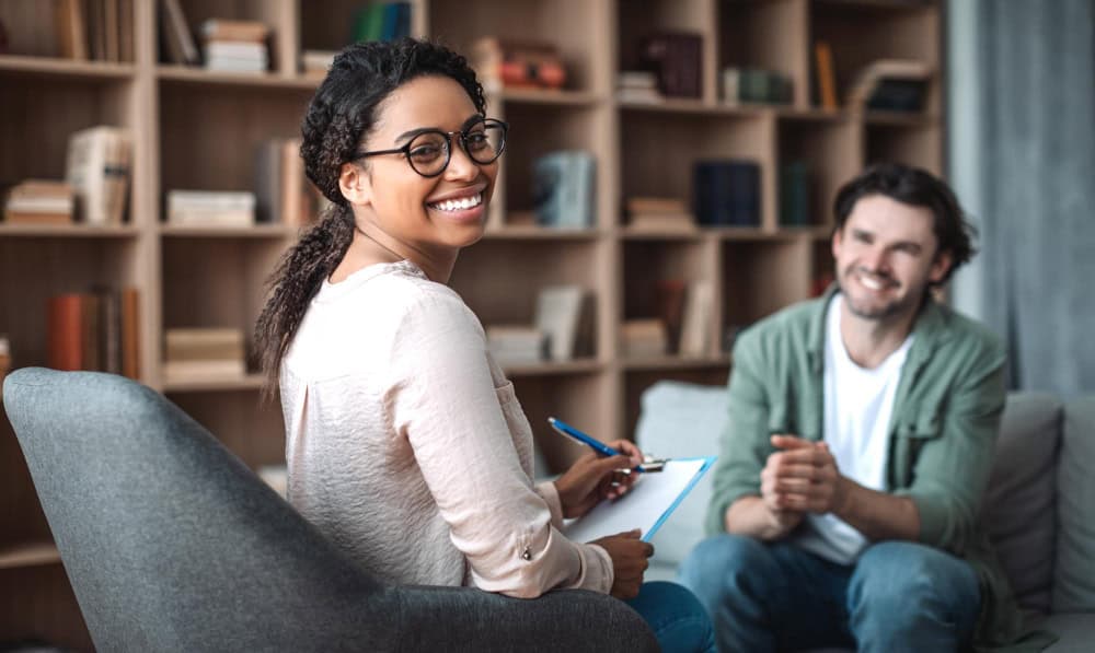 Smiling female psychologist representing professional care at an alcohol rehab that takes Aetna.