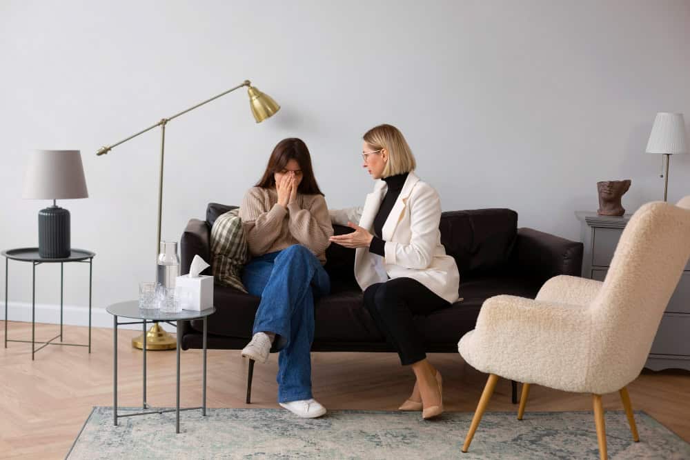 Distressed young woman speaking with a therapist about whether ADHD meds are addictive.