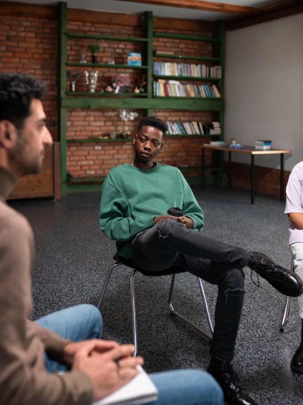 People meeting in support group during co-ocurring disorder treatment in Massachusetts